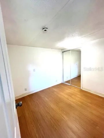 an empty room with wooden floor