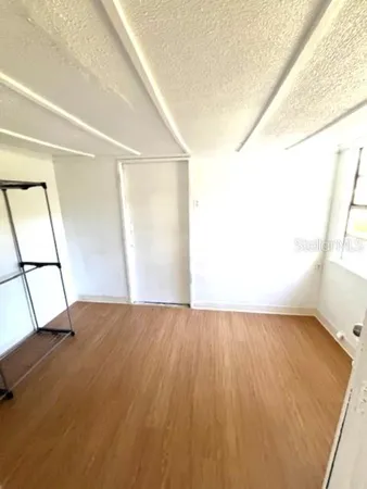 a view of an empty room and wooden floor