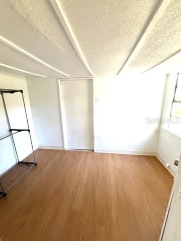 a view of an empty room and wooden floor