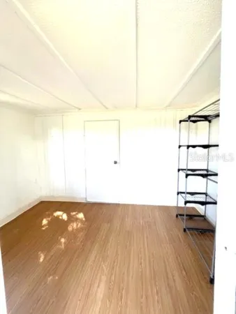 a view of a room with wooden floor