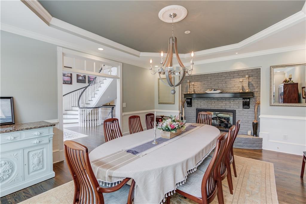 1345 Chandler Road Lawrenceville, GA 30045 - Photo 15 of 97 a view of a dining room with furniture a chandelier and wooden floor
