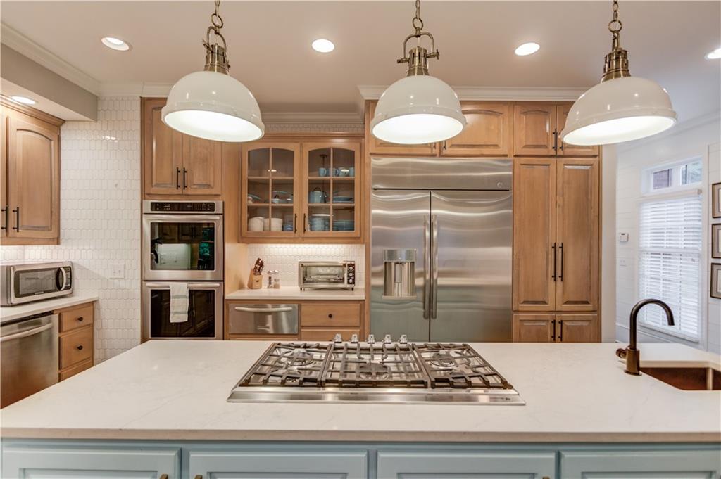 1345 Chandler Road Lawrenceville, GA 30045 - Photo 23 of 97 a kitchen with stainless steel appliances granite countertop a stove and a refrigerator