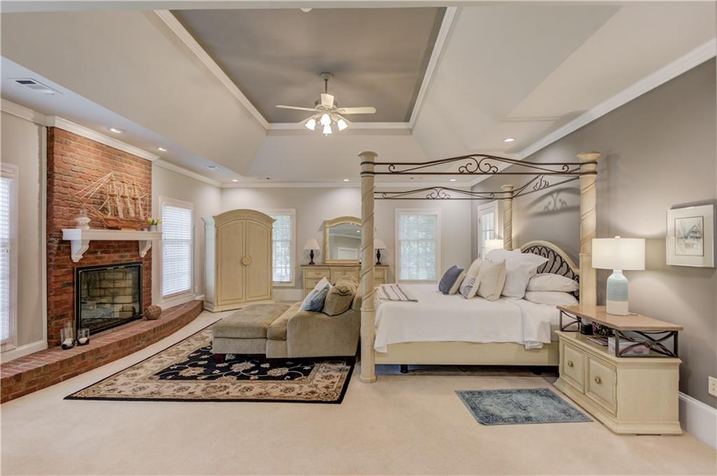 1345 Chandler Road Lawrenceville, GA 30045 - Photo 28 of 97 a living room with furniture a fireplace and chandelier