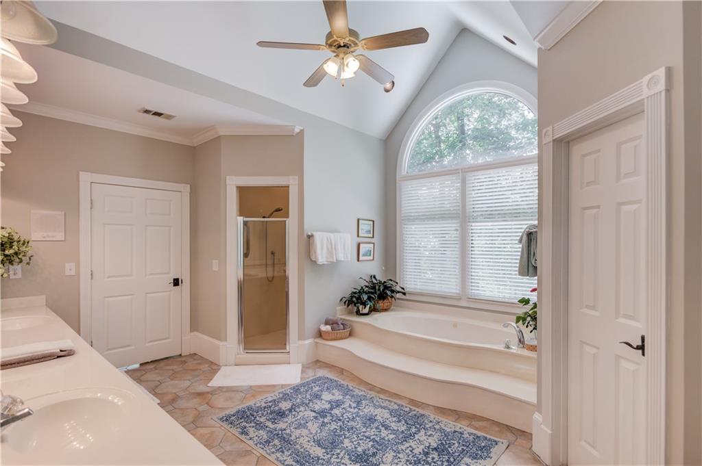 1345 Chandler Road Lawrenceville, GA 30045 - Photo 30 of 97 a spacious bedroom with a large bed and a chandelier