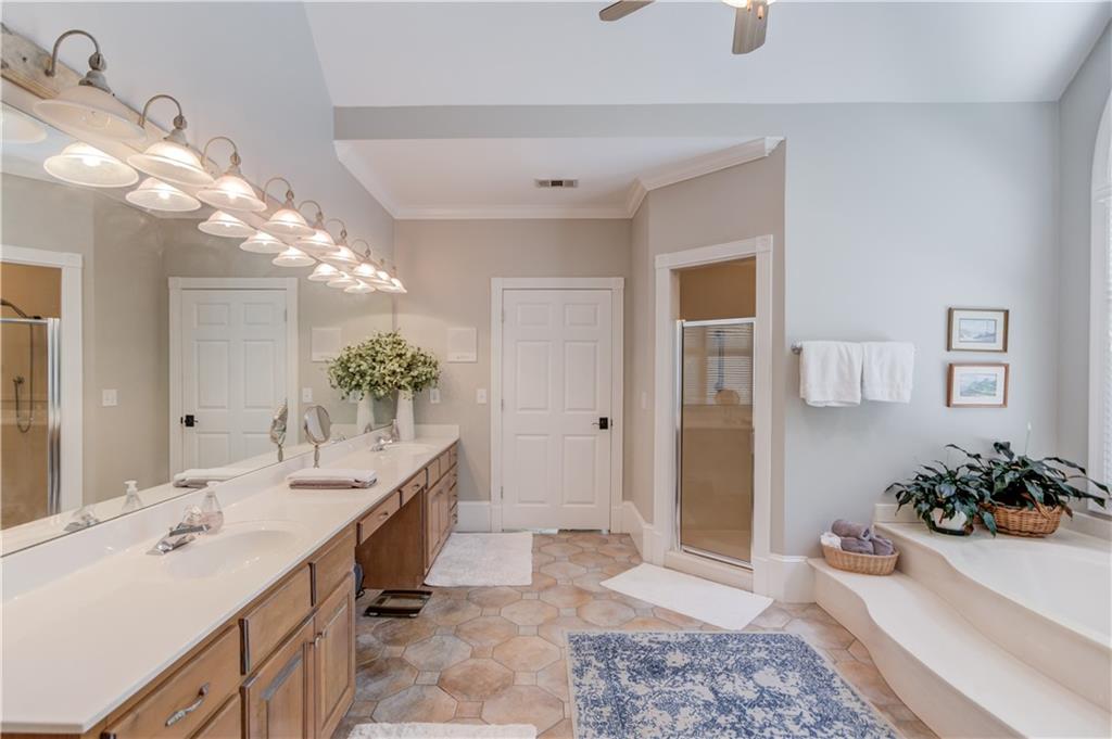 1345 Chandler Road Lawrenceville, GA 30045 - Photo 31 of 97 a spacious bathroom with a granite countertop sink a mirror and a shower