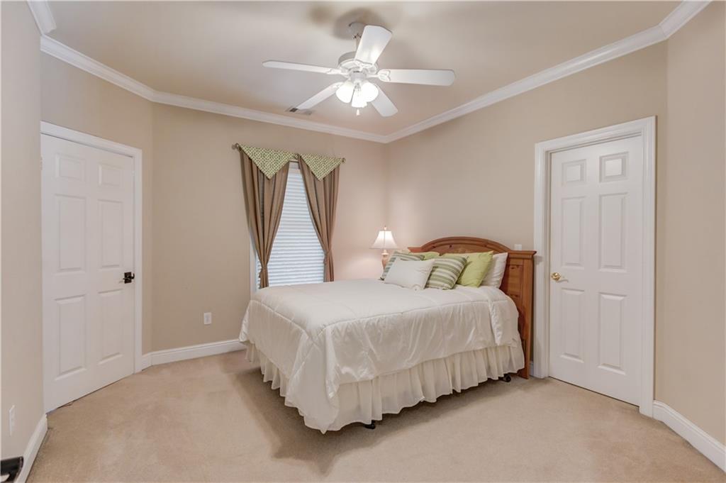 1345 Chandler Road Lawrenceville, GA 30045 - Photo 45 of 97 a bedroom with a bed and a ceiling fan