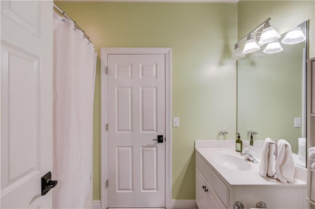 1345 Chandler Road Lawrenceville, GA 30045 - Photo 50 of 97 a bathroom with a sink a mirror and vanity