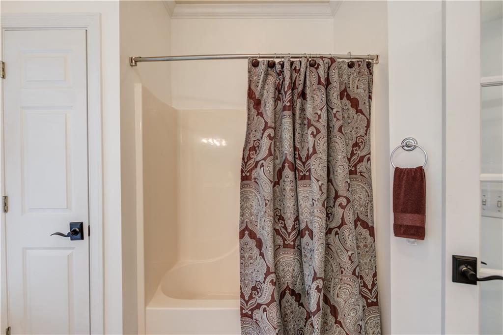 1345 Chandler Road Lawrenceville, GA 30045 - Photo 54 of 97 a bathroom with a shower curtain and a curtain