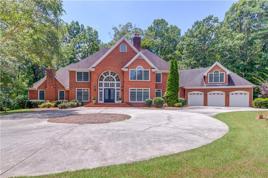 1345 Chandler Road Lawrenceville, GA 30045 - Photo 94 of 97 a front view of a house with yard and green space