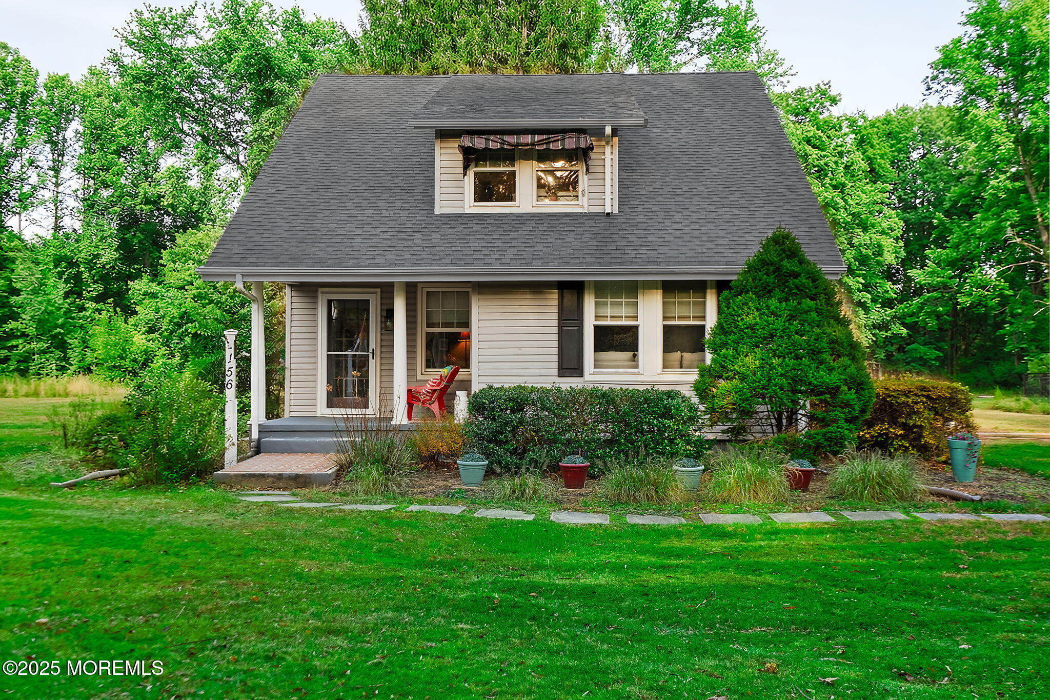 a view of a house with a yard and plants
