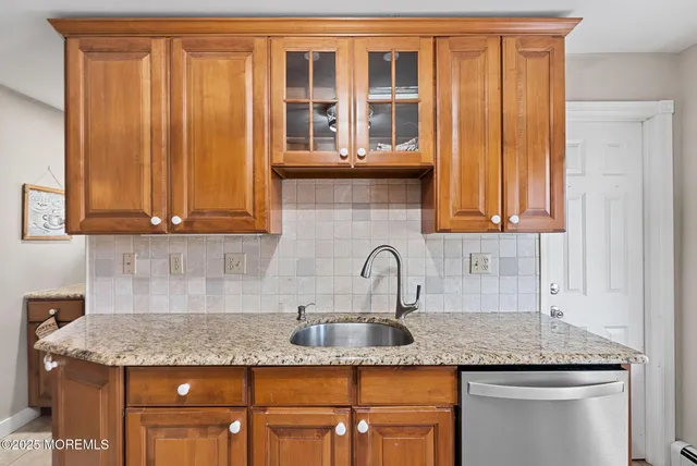 a kitchen with granite countertop stainless steel appliances a sink and cabinets