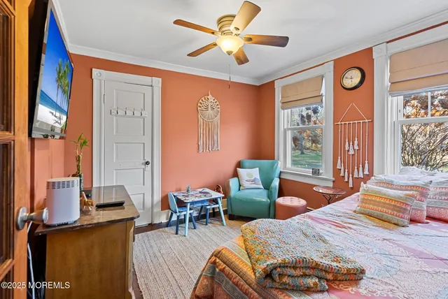 a bedroom with furniture and a large window