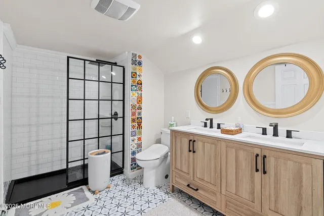 a bathroom with a toilet a sink and a mirror