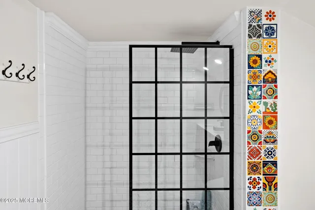 a bathroom with a window and a shower