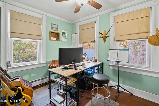 a view of a workspace with furniture and a window