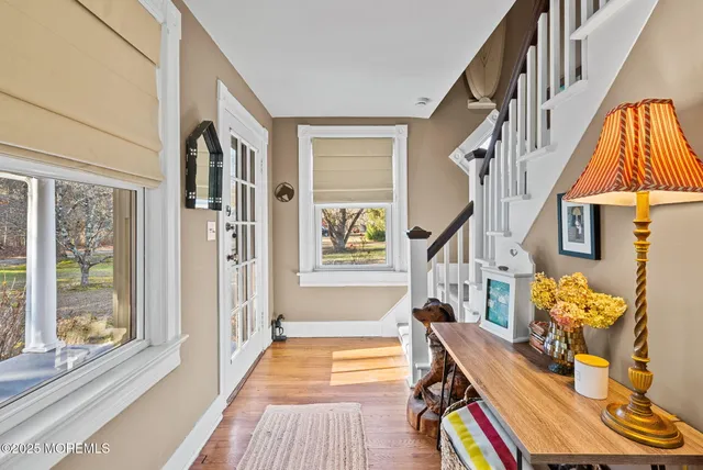a view of an entryway with wooden floor and windows