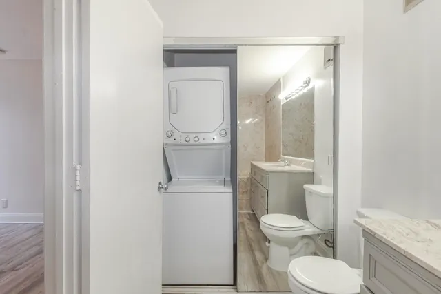 a white toilet sitting next to a bathroom sink