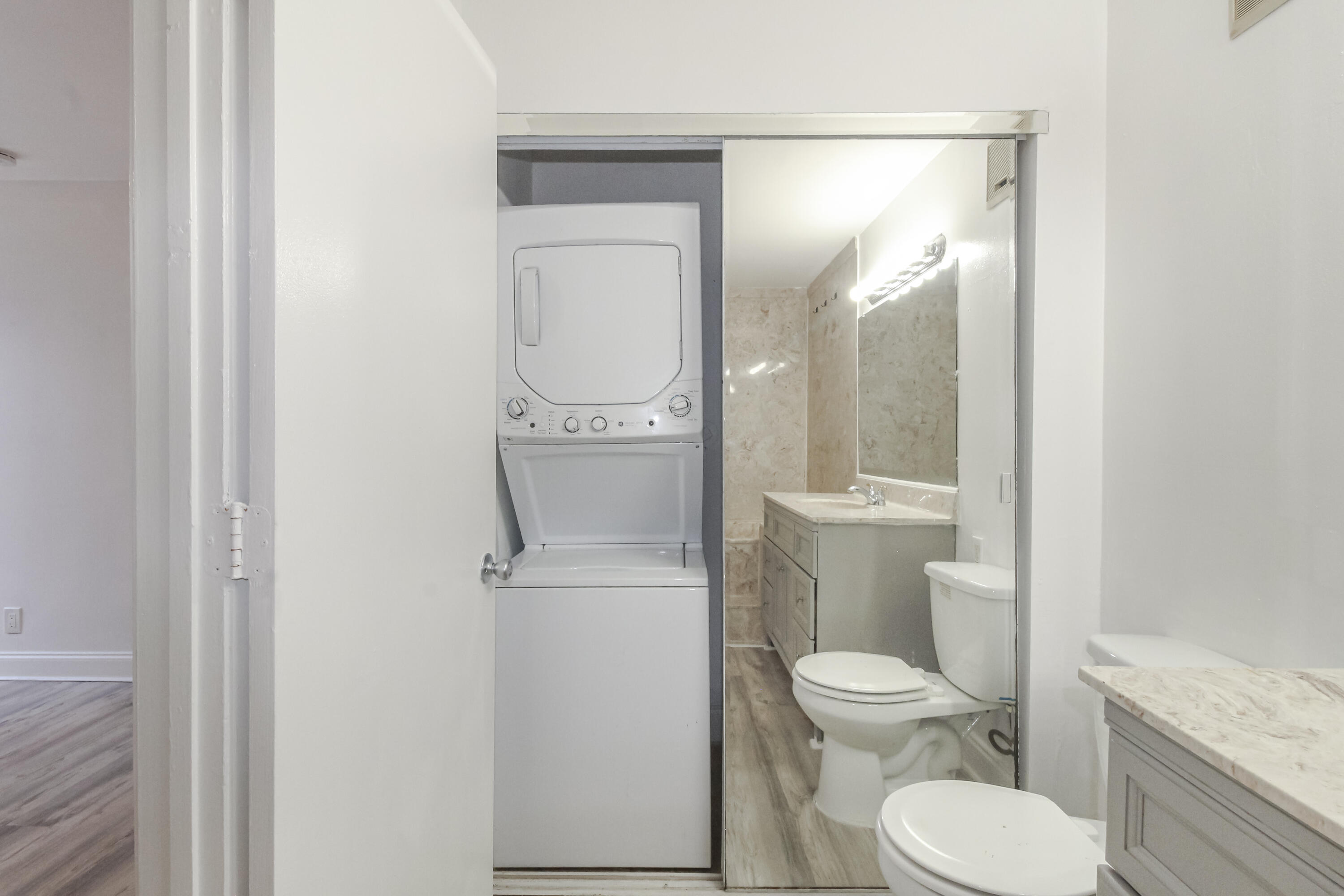 21 Crossings Circle, Unit B Boynton Beach, FL 33435 - Photo 11 of 12 a white toilet sitting next to a bathroom sink