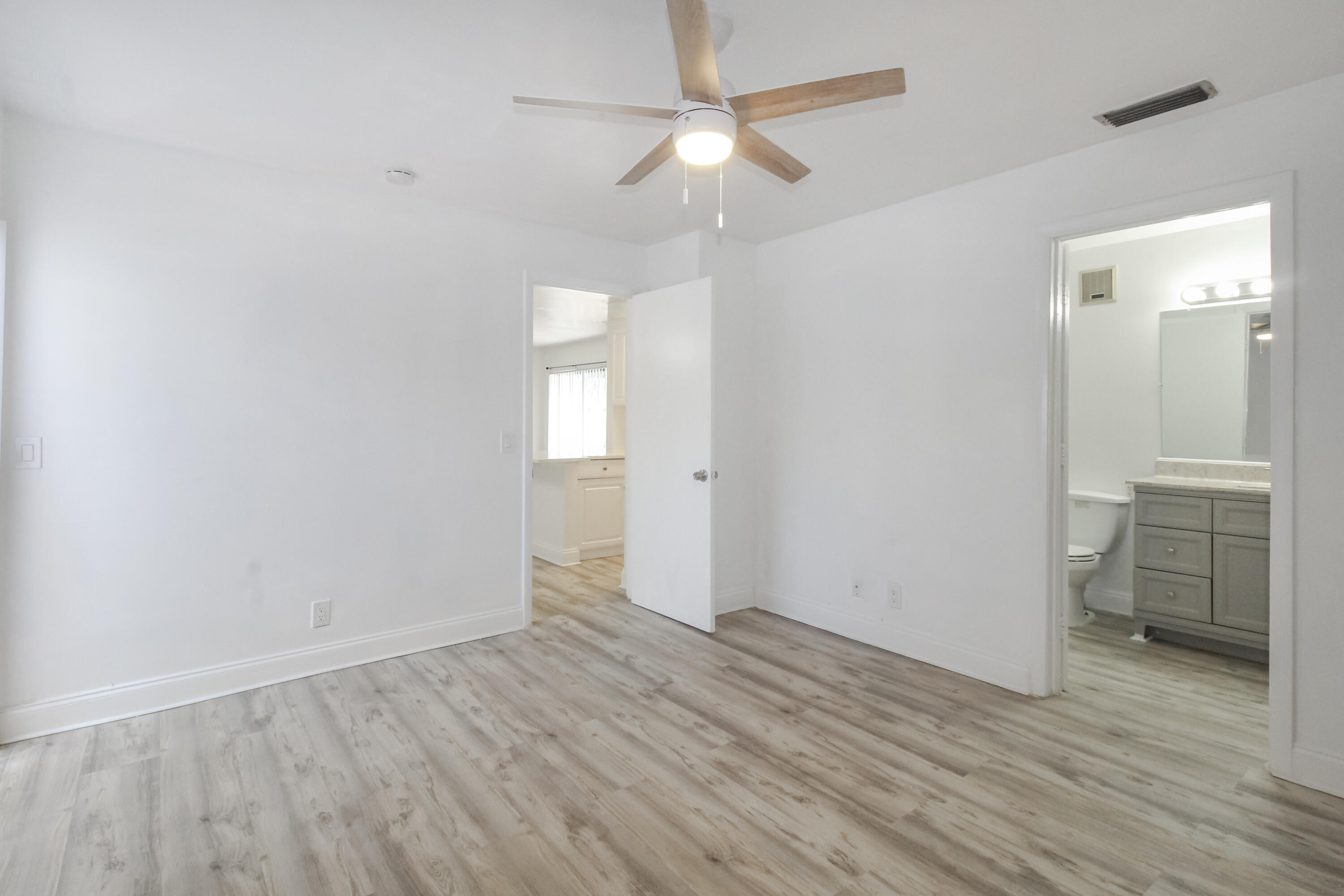 21 Crossings Circle, Unit B Boynton Beach, FL 33435 - Photo 12 of 12 wooden floor in an empty room with a window