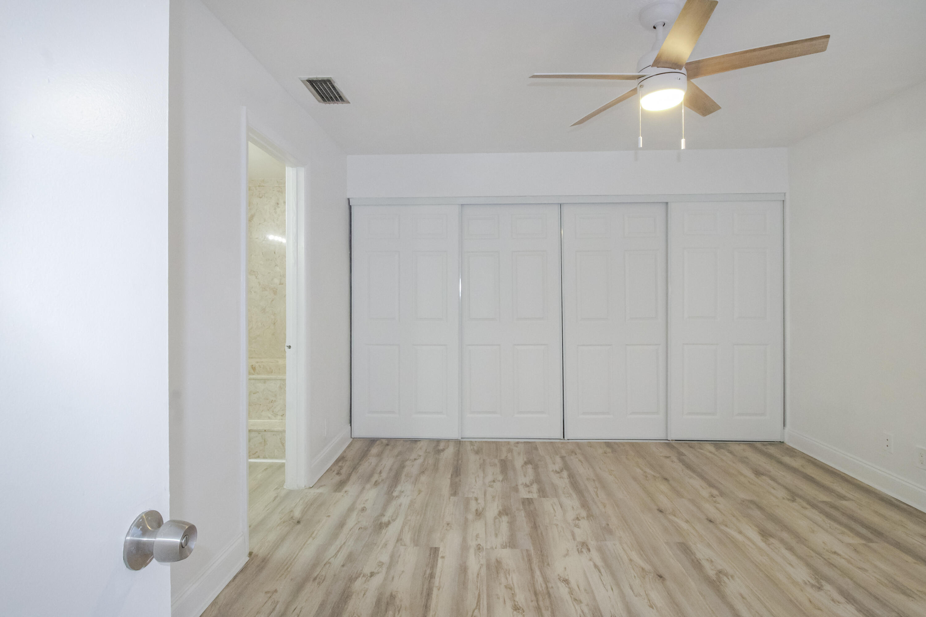 21 Crossings Circle, Unit B Boynton Beach, FL 33435 - Photo 9 of 12 wooden floor in an empty room