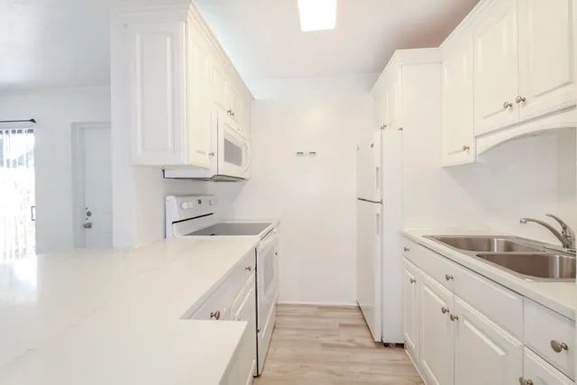 a kitchen with a sink a stove and refrigerator