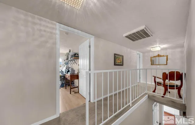 a view of a hallway with workspace and windows