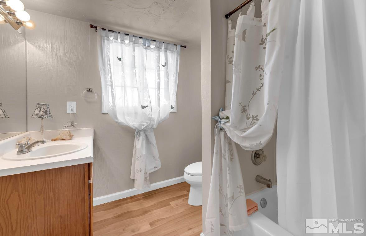 990 Riverview Drive Gardnerville, NV 89460 - Photo 20 of 40 a bathroom with a sink a toilet and shower curtain