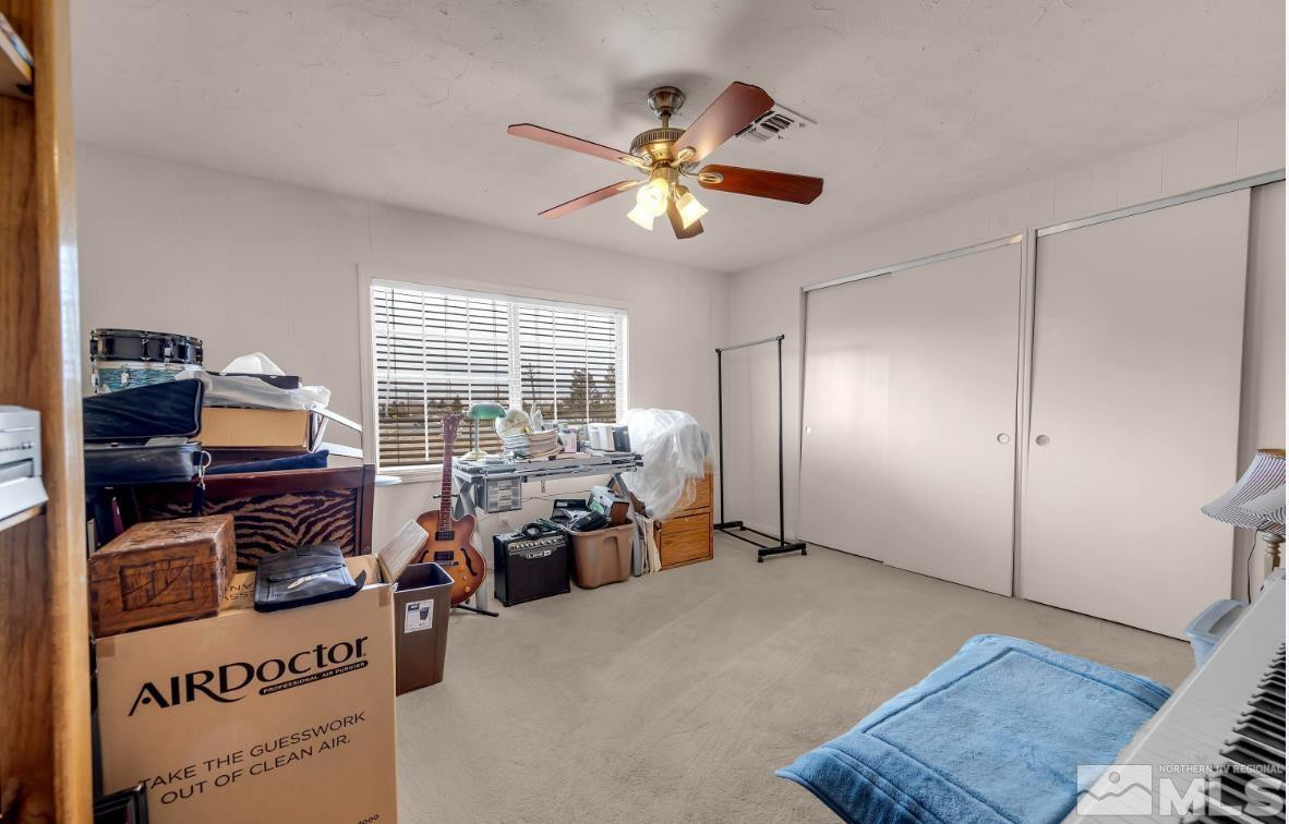 990 Riverview Drive Gardnerville, NV 89460 - Photo 21 of 40 a bedroom with furniture and a window
