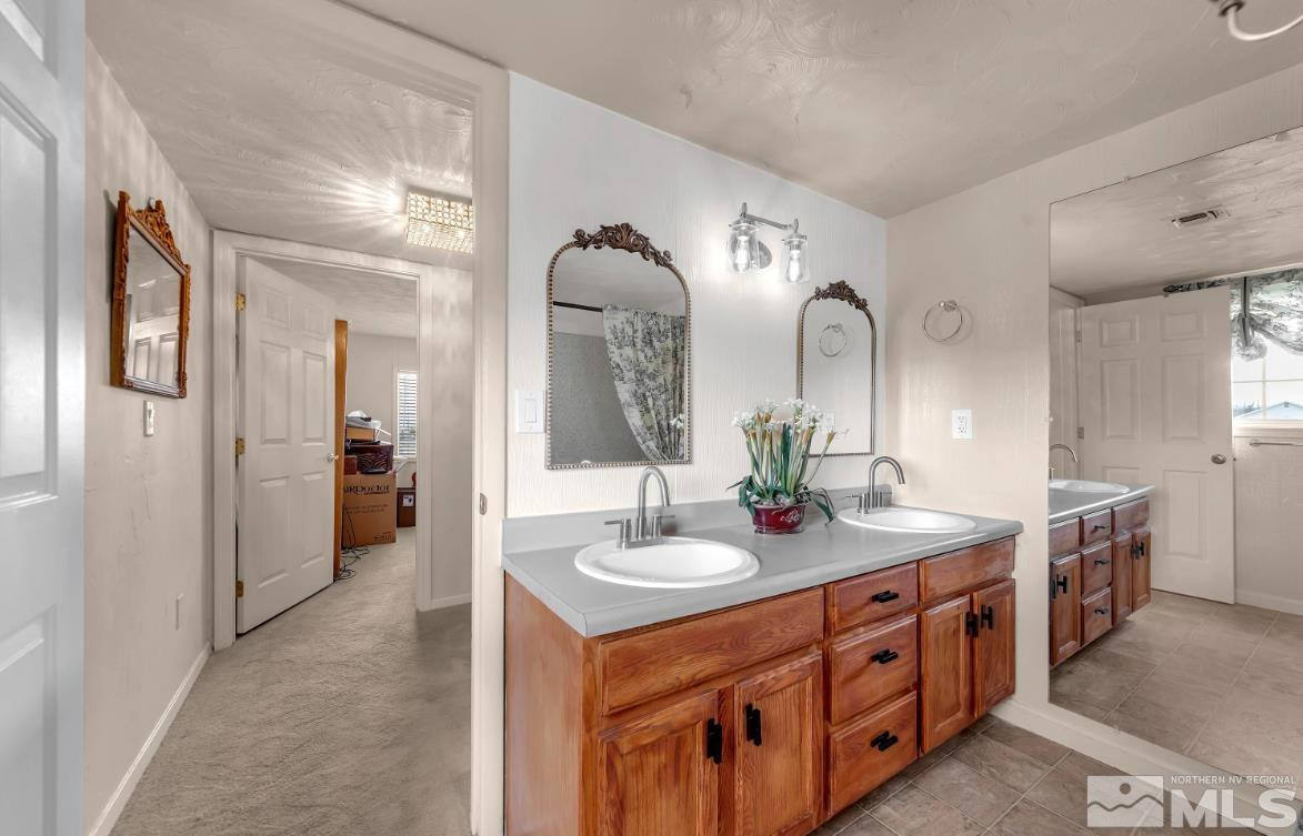 990 Riverview Drive Gardnerville, NV 89460 - Photo 23 of 40 a spacious bathroom with a double vanity sink and a mirror