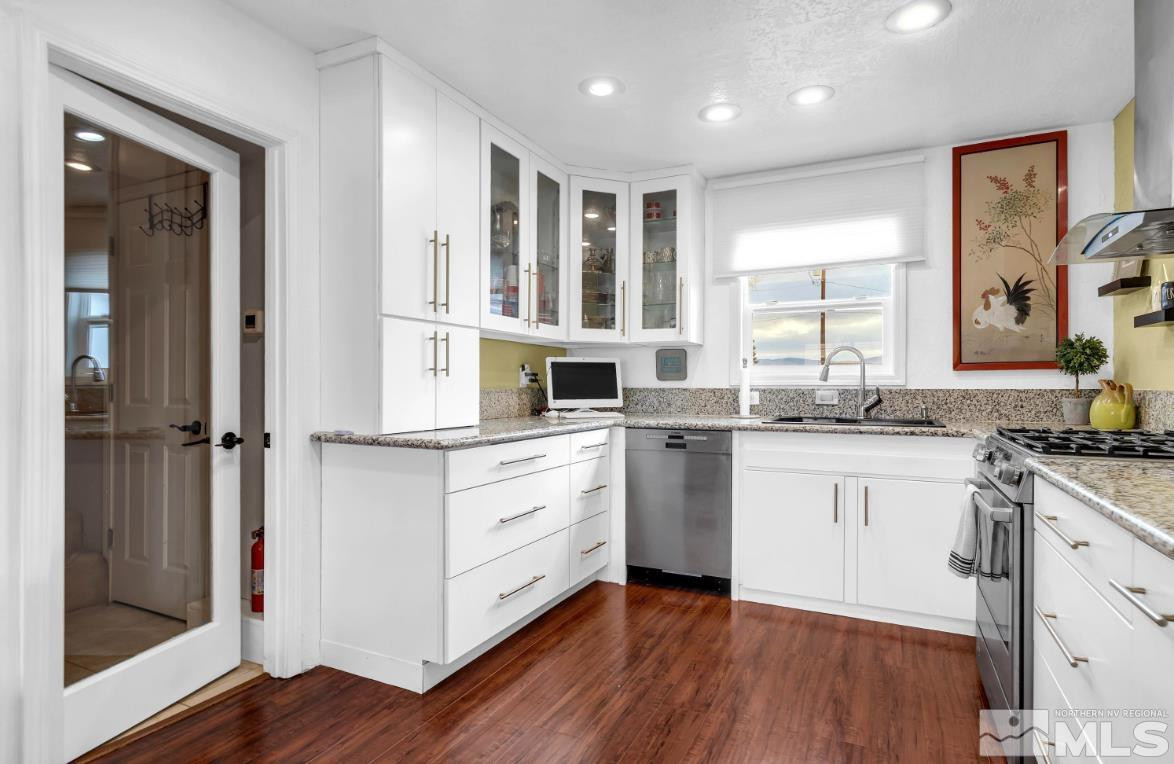 990 Riverview Drive Gardnerville, NV 89460 - Photo 31 of 40 a kitchen with granite countertop white cabinets and white appliances