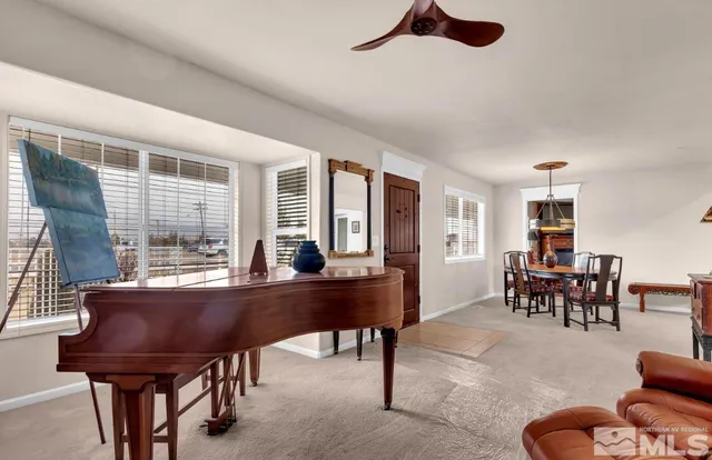 a living room with furniture a table and a large window