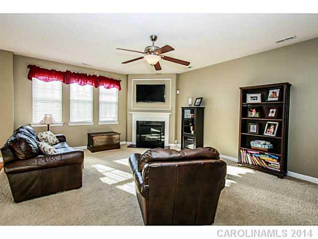 12106 Red Rust Lane Charlotte, NC 28277 - Photo 3 of 16 a living room with furniture a fireplace and a flat screen tv