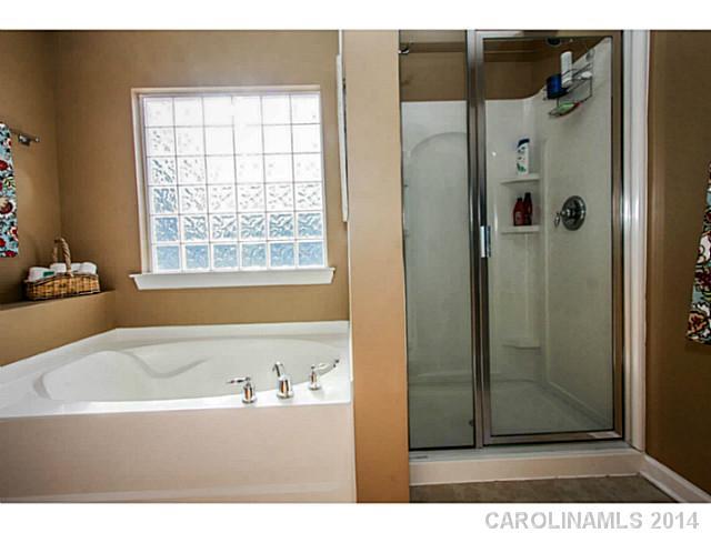 12106 Red Rust Lane Charlotte, NC 28277 - Photo 8 of 16 a bathroom with a bathtub and a shower