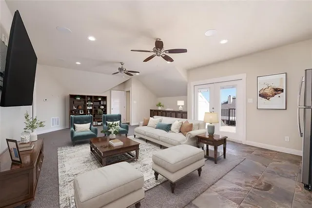 a living room with furniture a flat screen tv and a window