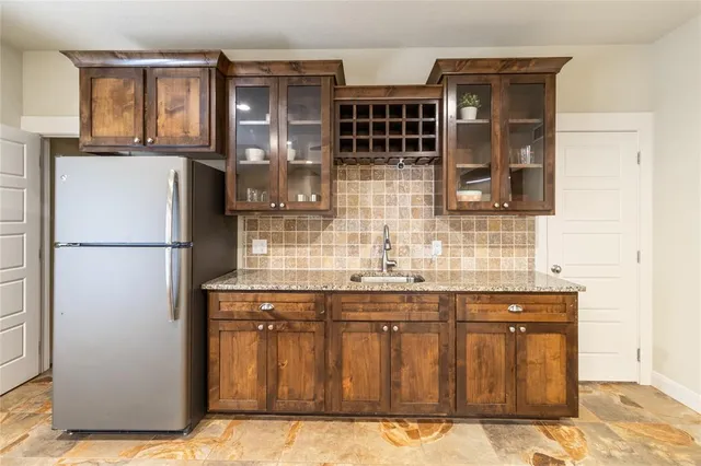 a kitchen with a refrigerator and cabinets
