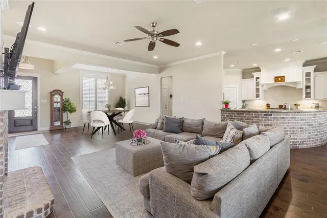 a living room with furniture and kitchen view