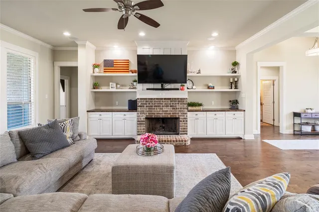 a living room with furniture flat screen tv and a fireplace