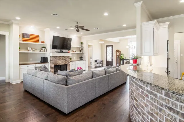 a living room with fireplace furniture and a flat screen tv