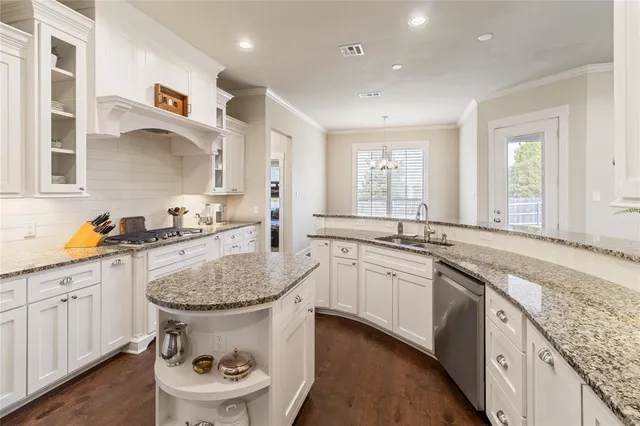 a kitchen with a sink stove and cabinets