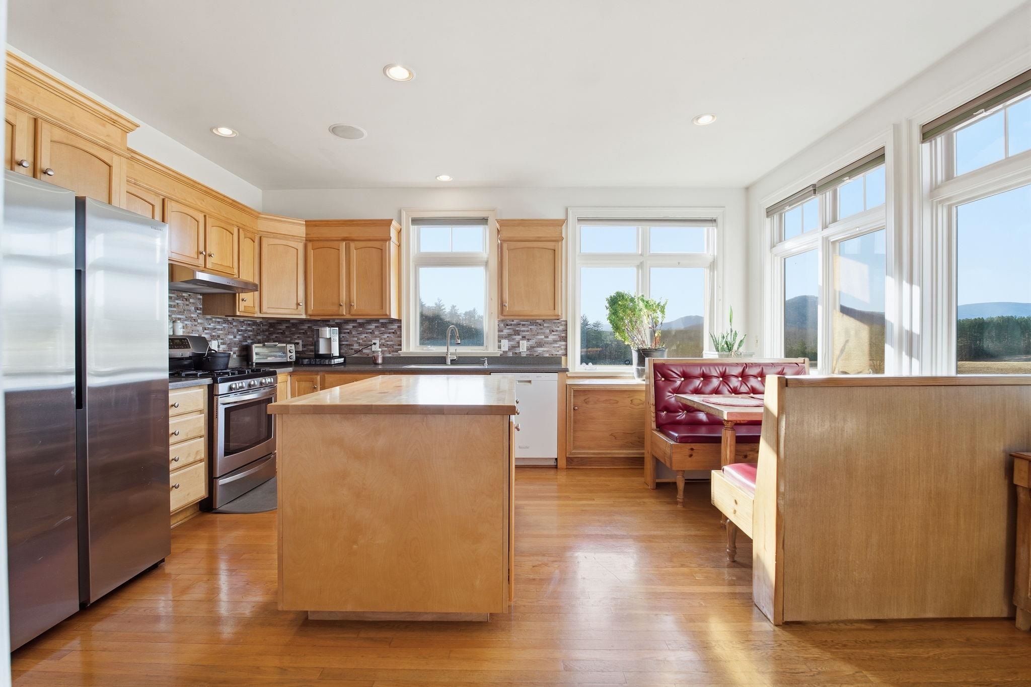 436 Chimney Rock Road Earlysville, VA 22936 - Photo 13 of 61 a kitchen with stainless steel appliances a refrigerator a sink dishwasher a stove with wooden cabinets and floor