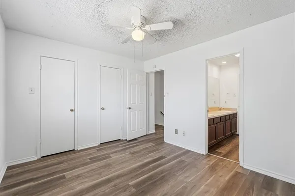 a view of an empty room with a ceiling fan