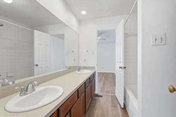 a bathroom with a bath tub with a shower
