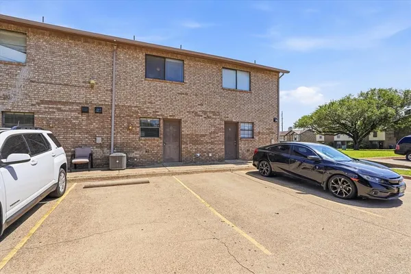 a car parked in front of a brick building