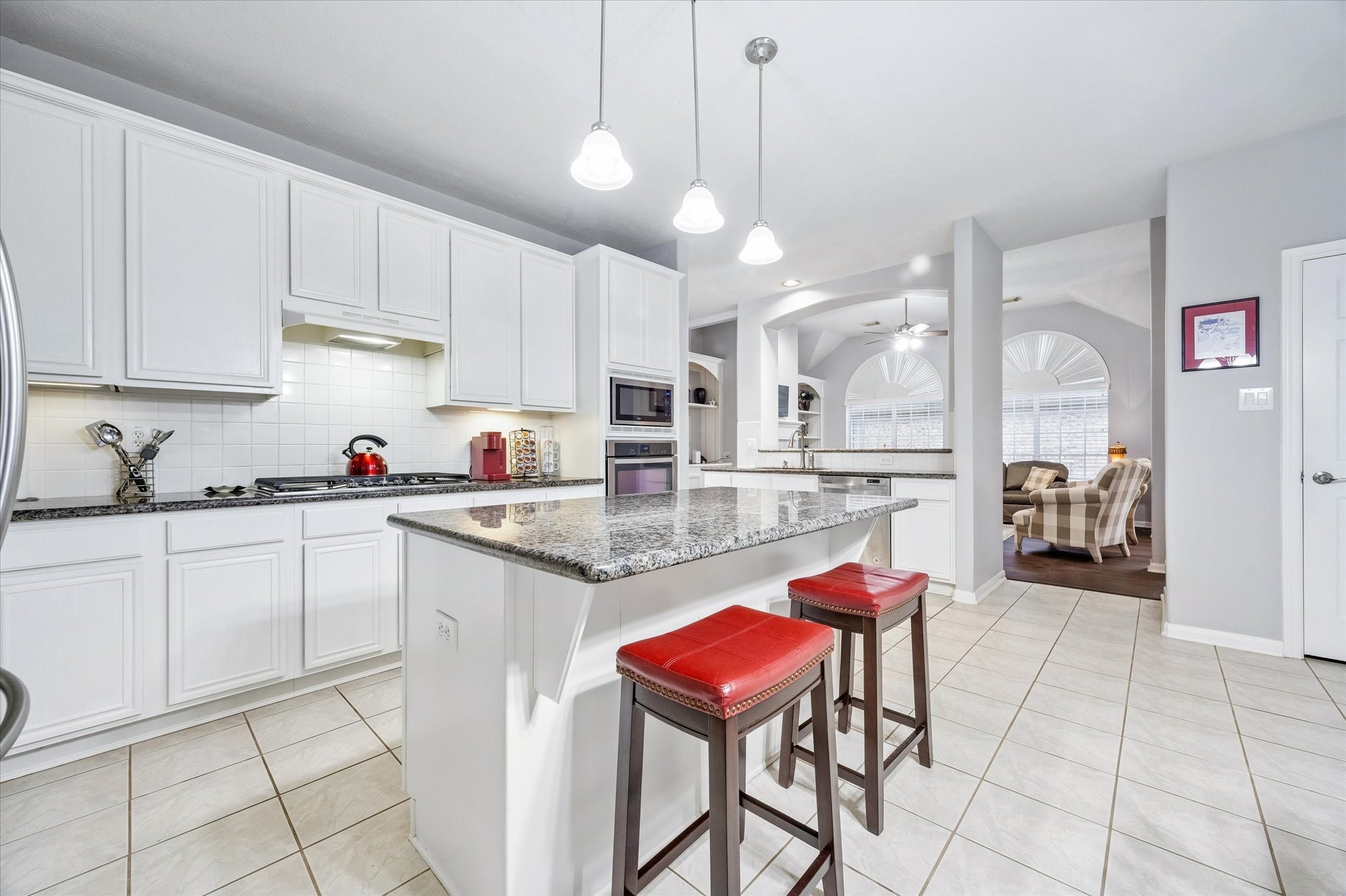 12423 Rutgers Park Court Houston, TX 77058 - Photo 15 of 29 a kitchen with stainless steel appliances kitchen island granite countertop a sink and cabinets