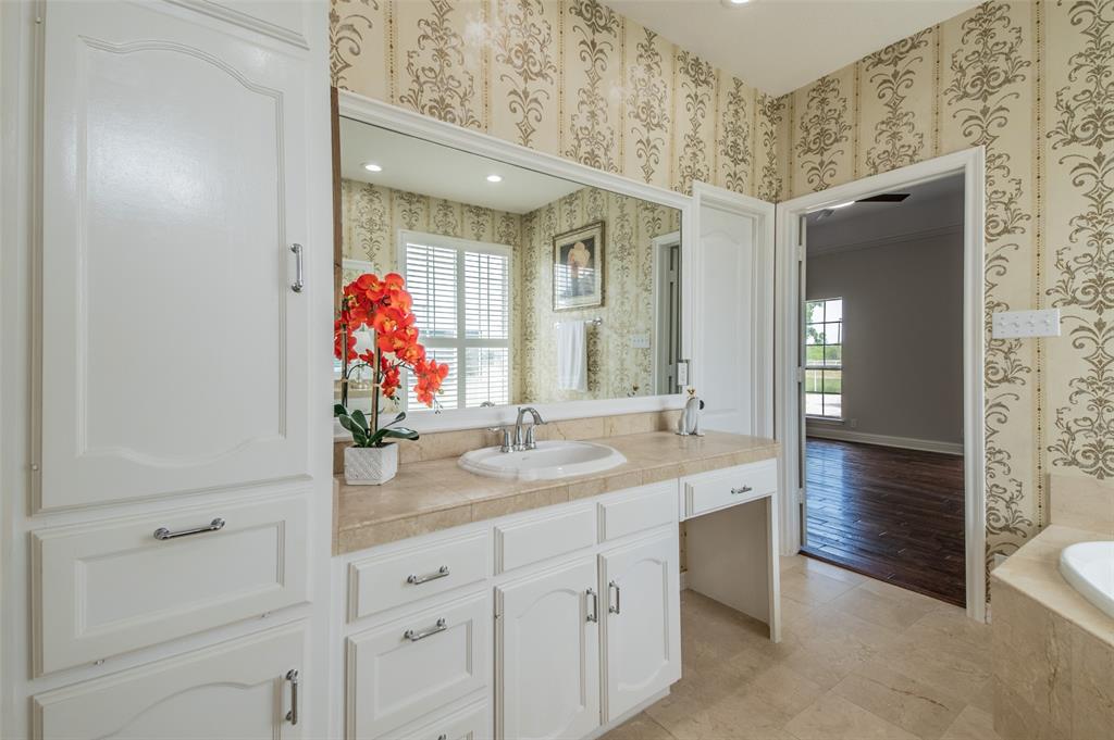 13507 Friendship Road Pilot Point, TX 76258 - Photo 16 of 39 a bathroom with a granite countertop sink and a mirror