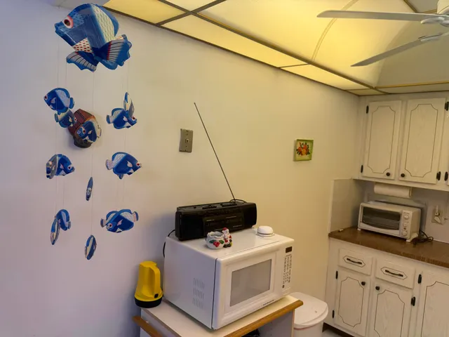 a white kitchen with a stove and a refrigerator