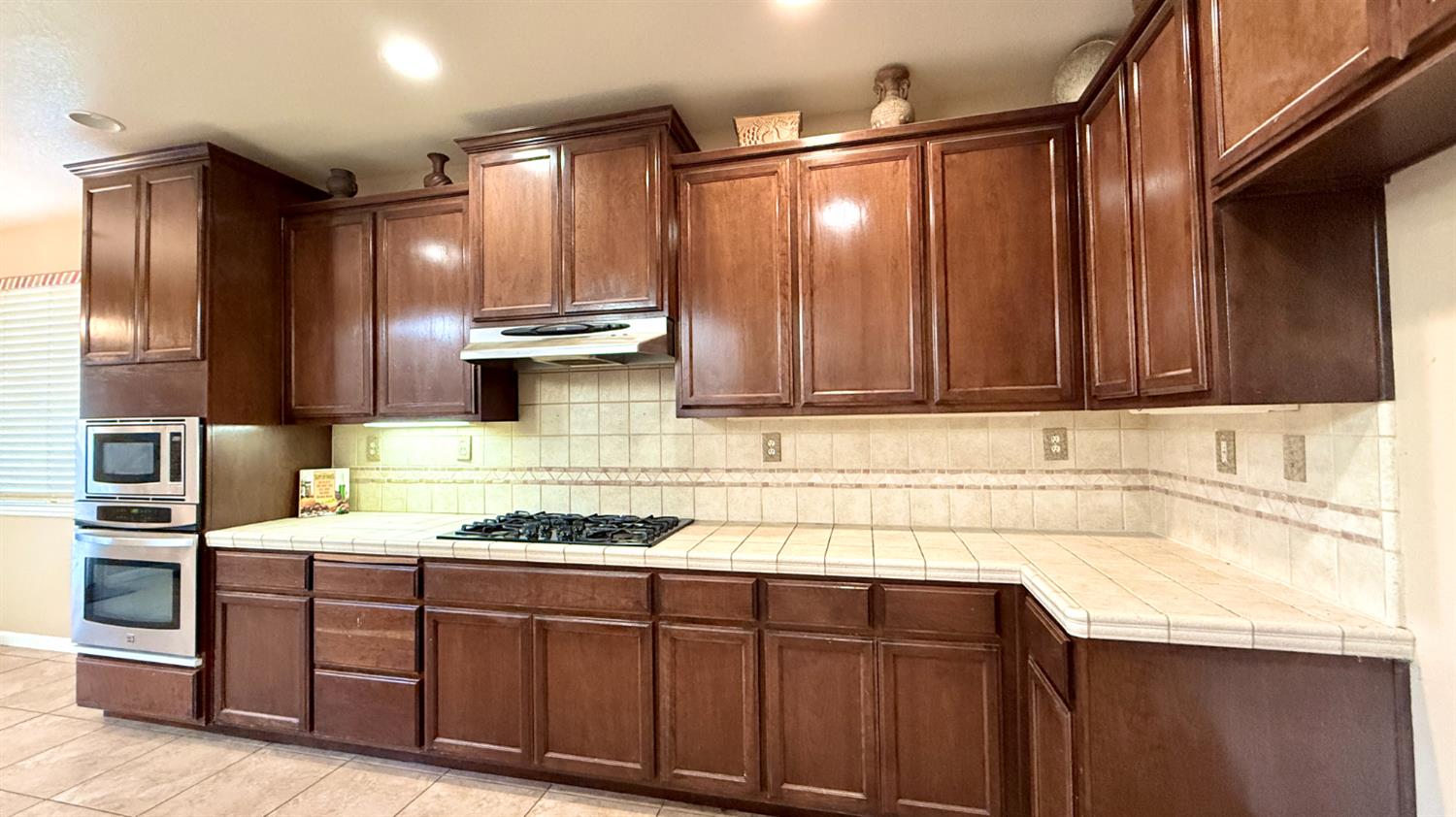 16206 Sand Bar Way Lathrop, CA 95330 - Photo 11 of 32 a kitchen with stainless steel appliances granite countertop wooden cabinets a sink and dishwasher