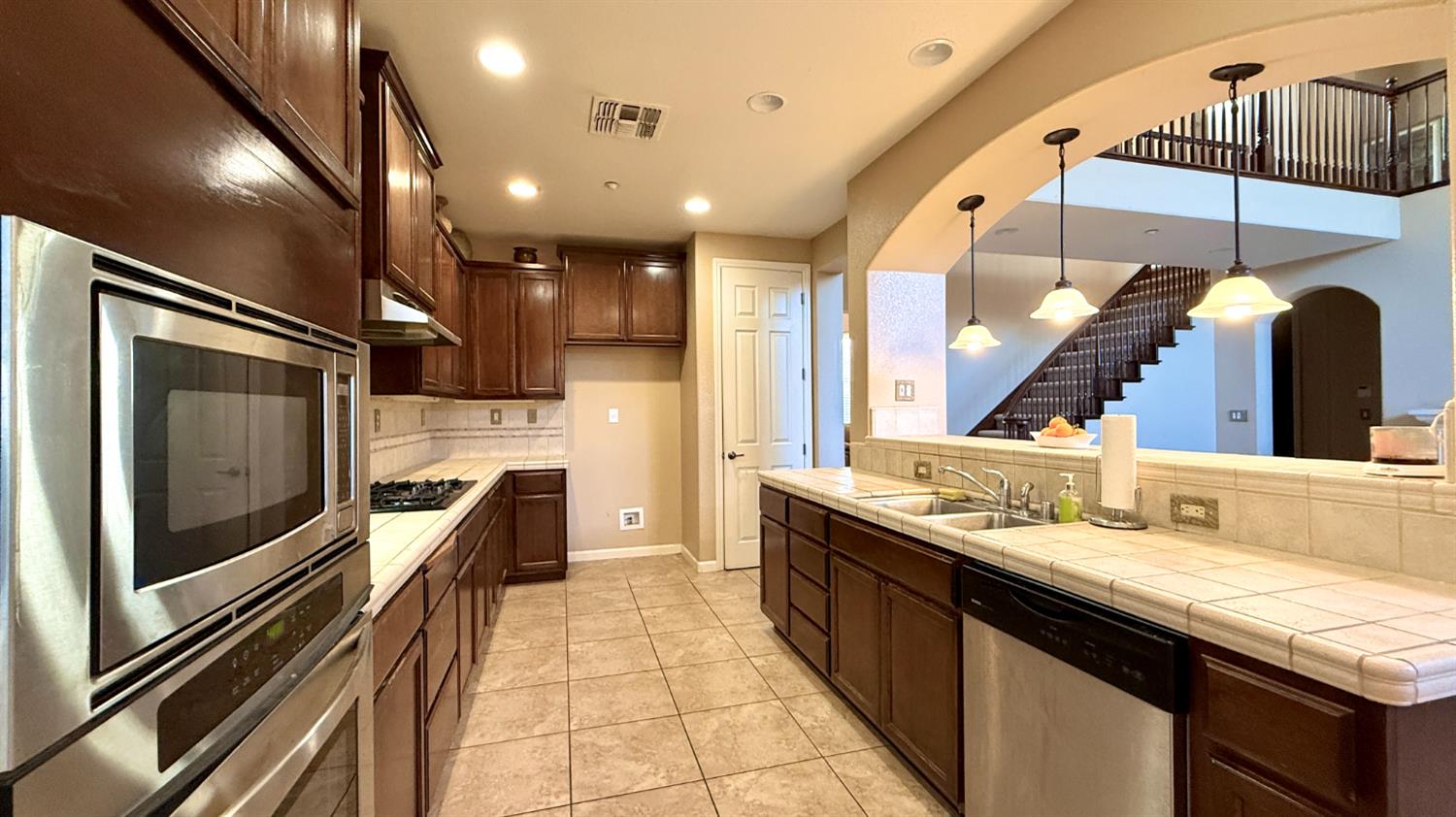 16206 Sand Bar Way Lathrop, CA 95330 - Photo 12 of 32 a bathroom with a double vanity sink and a mirror