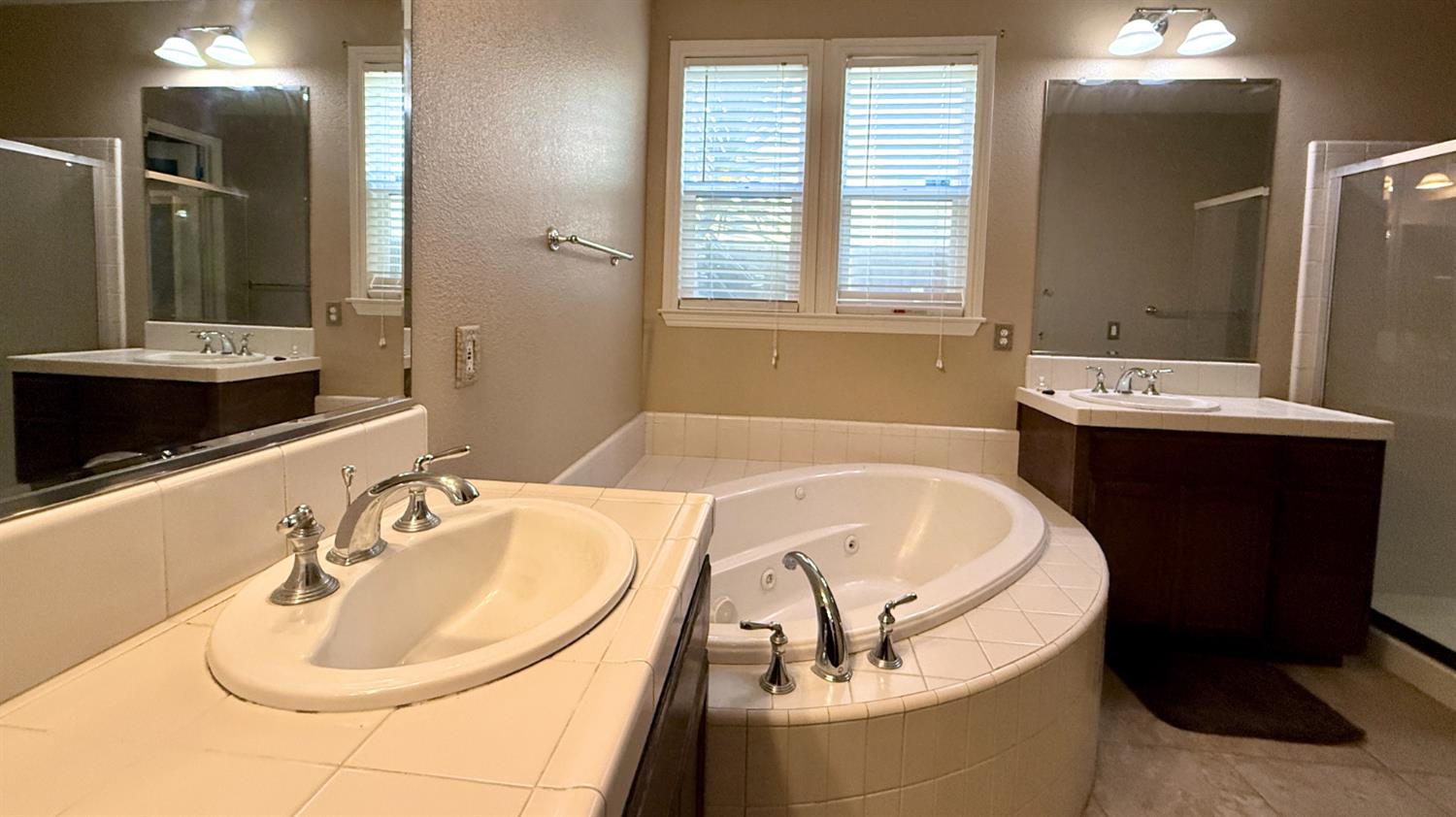 16206 Sand Bar Way Lathrop, CA 95330 - Photo 21 of 32 a bathroom with a tub sink and mirror