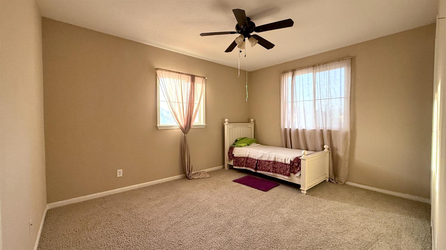 16206 Sand Bar Way Lathrop, CA 95330 - Photo 22 of 32 a spacious bedroom with a bed and a window